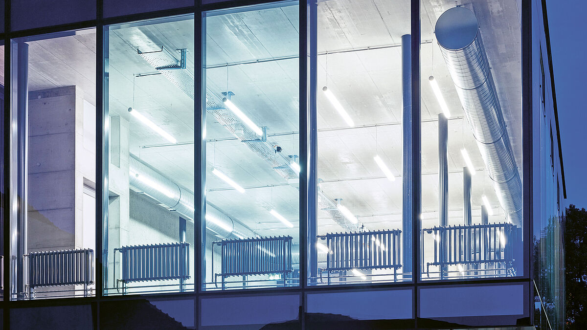 De nuit, elle permet de voir clairement l’intérieur du bâtiment éclairé. Les installations techniques du bâtiment sont visibles.